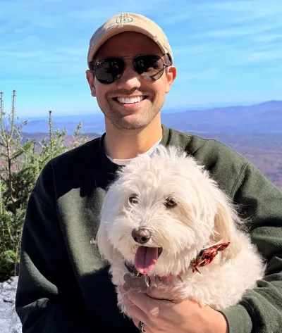 Conner Ellsworth, REALTOR, with his dog on a Vermont mountain summit