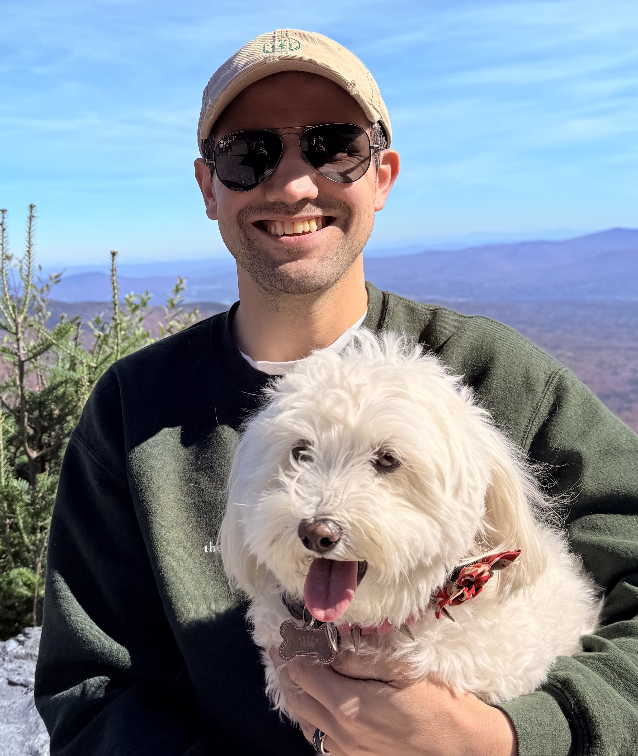 Conner Ellsworth, REALTOR, with his dog on a Vermont mountain summit