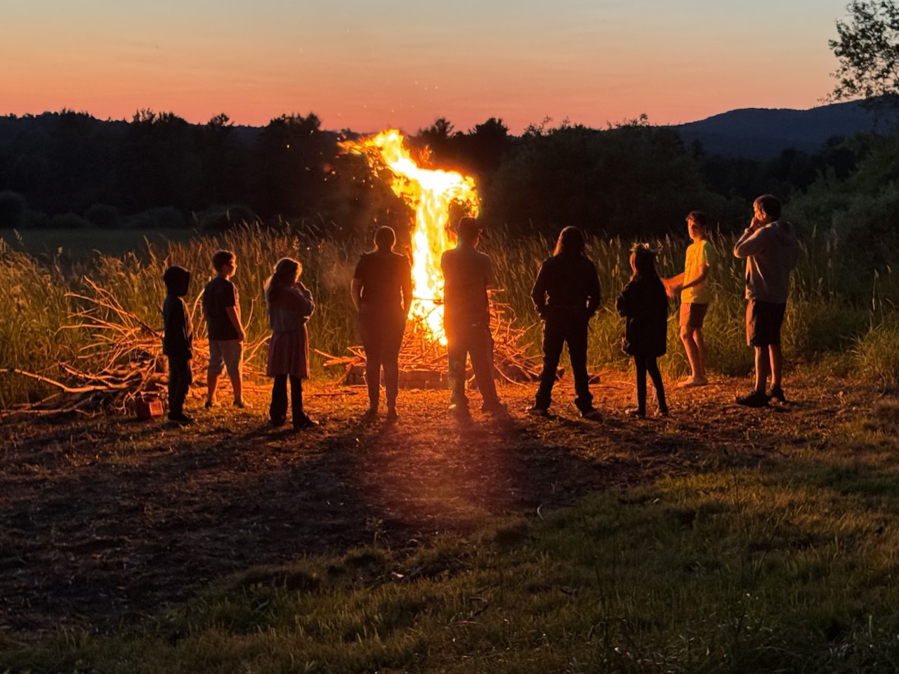 Community bonfire at sunset in northern Vermont